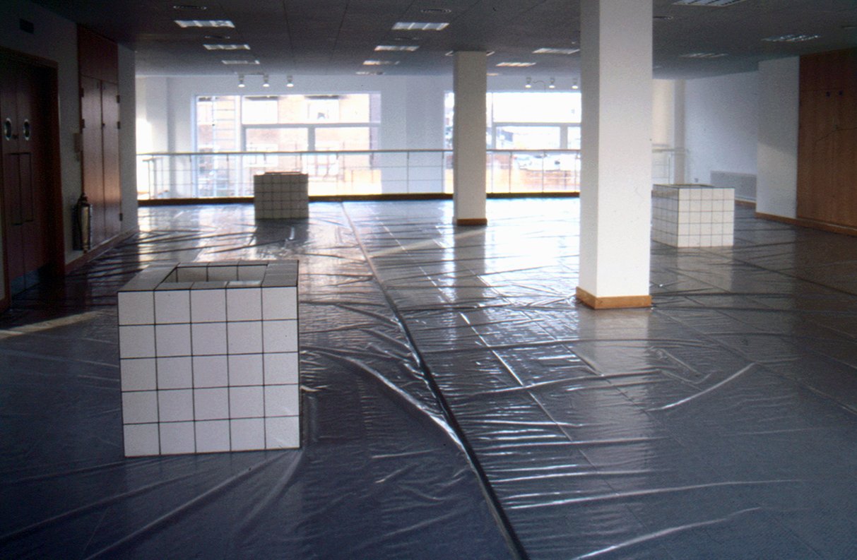 White-tiled, cuboid sculptures containing canal water